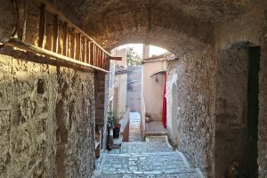 Sunlit alley with wooden staircase in Volturara Appula